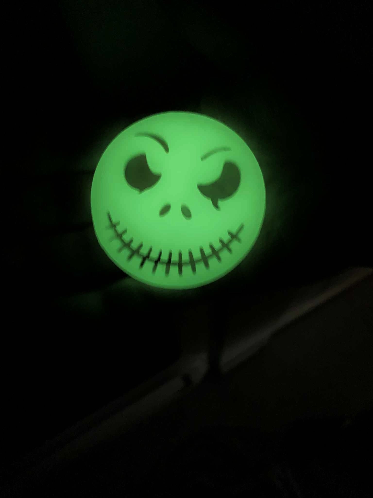 Glow-in-the-dark Jack Skellington soap glowing between black and clear layers, pumpkin spice Halloween scent