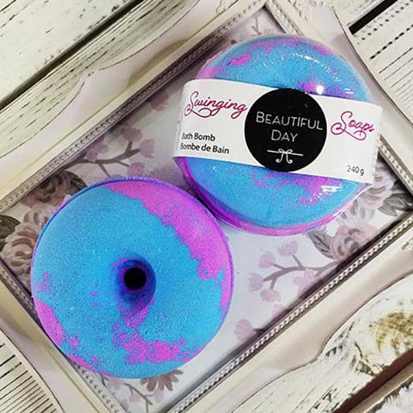 Indulge in our Bath Bomb Donut - stunning purple and blue foam, scented with Beautiful Day for a blissful bath experience.
