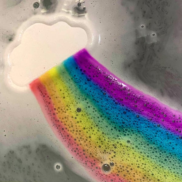 Demonstration of Rainbow Bath Bomb Cloud Creating Vibrant Colors in the Tub