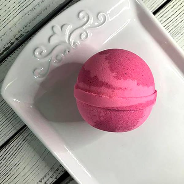 Round Bath Bomb - Champagne Kisses: Indulgent pink, coral, and gold blend for a bubbly bath experience