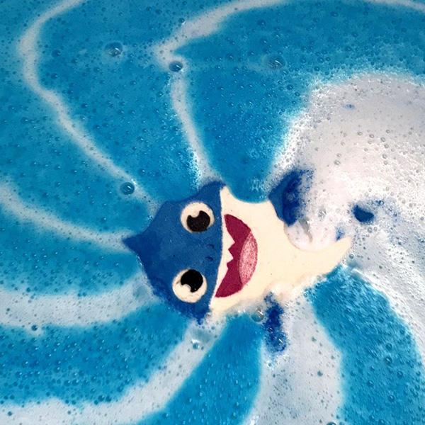 Blue shark bath bomb fizzing and releasing colour into bath water