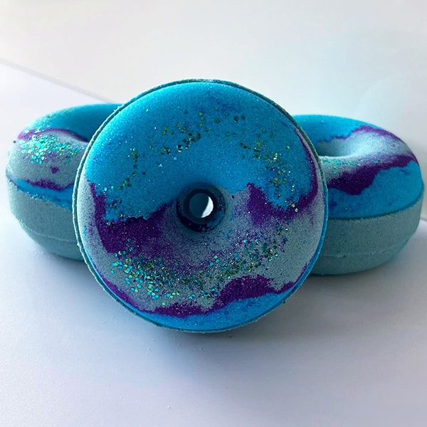 Our most popular Ocean themed bath bomb donuts artfully arranged on a white background