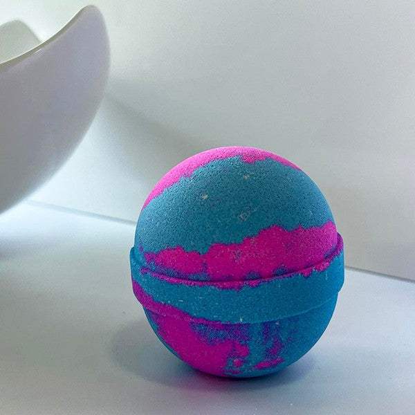Vibrant pink and blue round bath bomb with sweet cotton candy scent.

